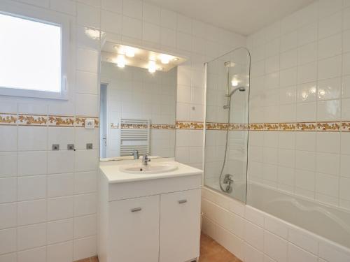 a white bathroom with a sink and a shower at Luxury Villa in France with Pool in Vasles