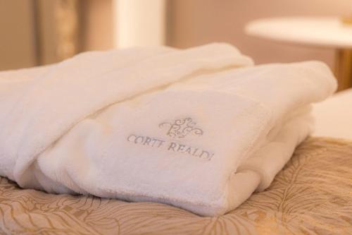 a white towel sitting on top of a bed at Corte Realdi - Palazzo Camozzini in Verona