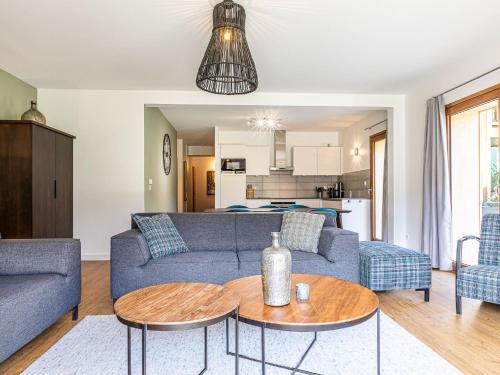 a living room with a couch and a table at Alpine Retreat w Sauna in Abondance