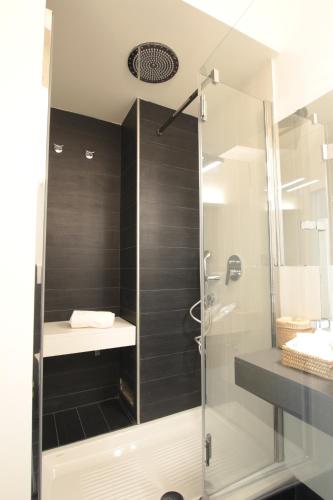 a bathroom with a shower with a glass door at Marcona24 in Milan