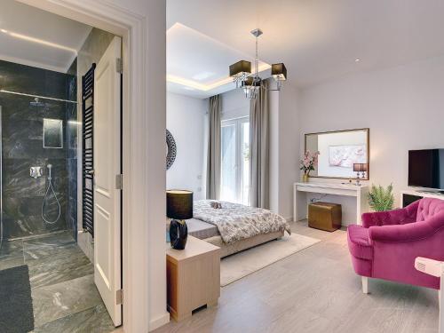 a bedroom with a bed and a pink couch at Villa in Premantura with Pool near Beach in Premantura