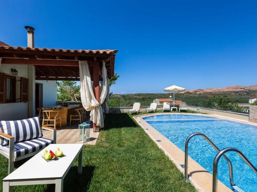 a villa with a swimming pool and a patio at Villas in Crete with Private Pool & Beaches in Achlades