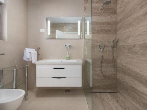 a bathroom with a white sink and a shower at Apartment in Croatia near the Coast in Brtonigla