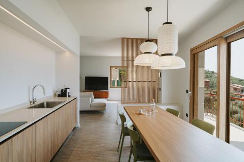 a kitchen and dining room with a large wooden table at VIEW Garda Lake in Brenzone sul Garda