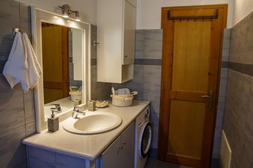 a bathroom with a sink and a mirror at DP Homes Paros in Angairiá