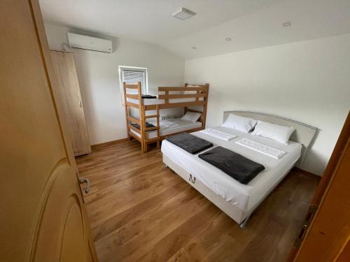 a small bedroom with a bed and a desk at vila sunset in Konjic