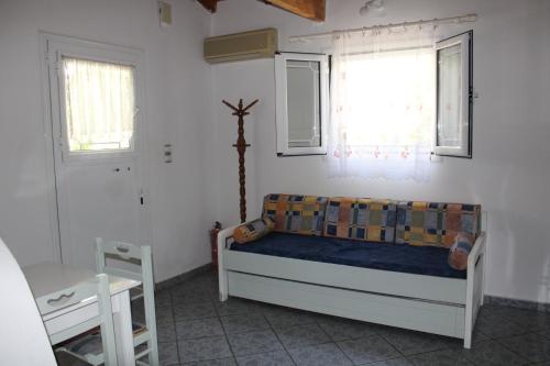 a bedroom with a bed and a window at Anastasia Apartments in Kámpos