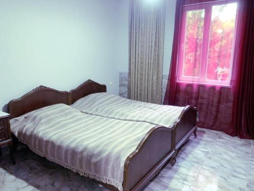 a bedroom with a bed and a window at Nargizi guest house in Gonio