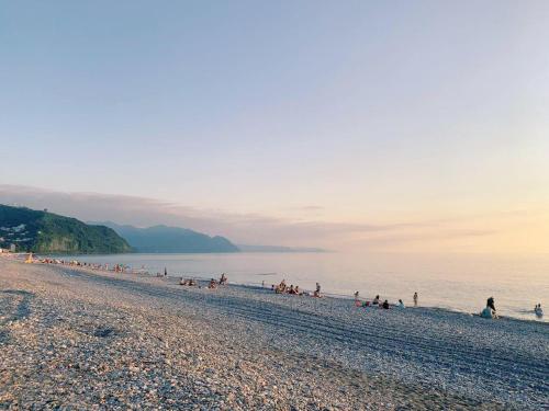 a group of people on a beach near the water at Nargizi guest house in Gonio
