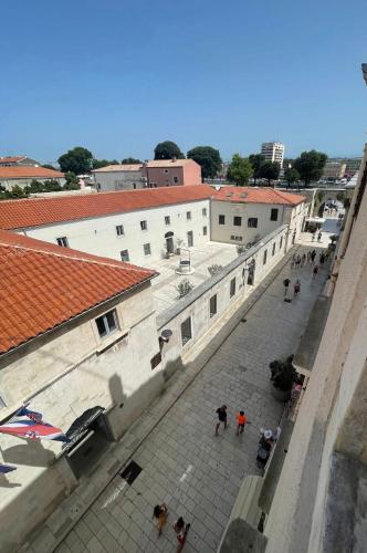 a group of people walking down a street with buildings at Zadar Enjoy Apartment in Zadar