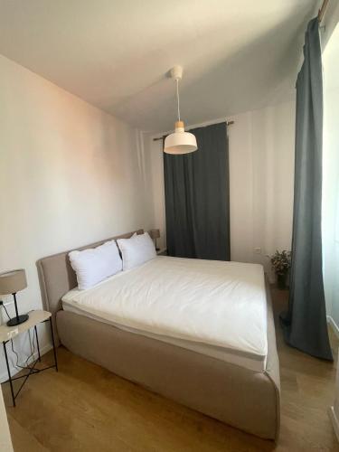 a bedroom with a large white bed and a window at Zadar Enjoy Apartment in Zadar