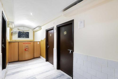 a hallway with two doors in a room at Hotel O Capital in Rajkot
