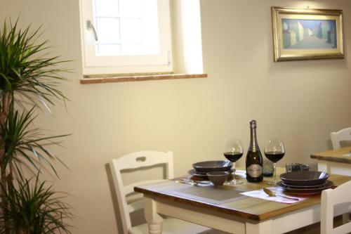 a dining room table with two glasses of wine at matana b&b in Carmignano