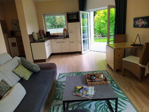 a living room with a couch and a table at Entspannen im Grünen, Ferienwohnung mit eigenem Garten in Keilberg