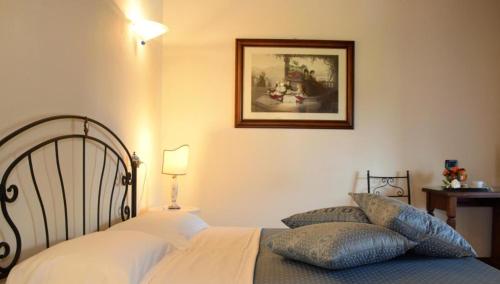 a bedroom with a bed and a picture on the wall at Isola Di Caprera in Mira