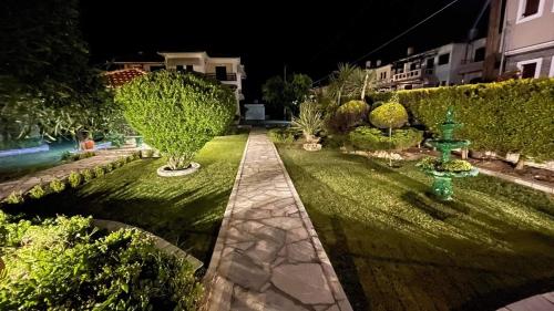 a garden at night with a green fire hydrant at Anemos Pelion Seaview in Kala Nera