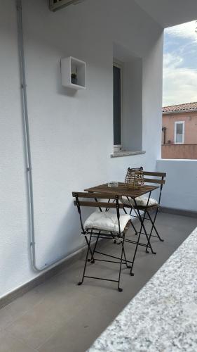a table and a chair sitting on a patio at Sunrise Sardinia Posada in Posada