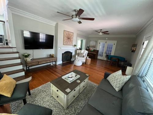 a living room with a couch and a flat screen tv at St Petersburg Vacation Rentals in St Petersburg