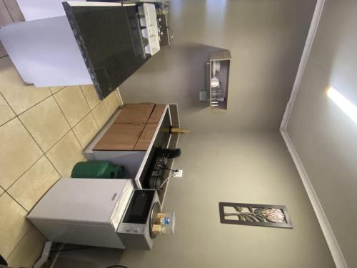 an overhead view of an empty stairwell with a machine at Menlyn Mews Guesthouse in Pretoria