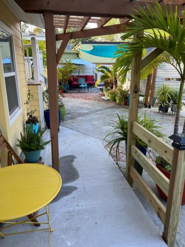 a patio with a yellow table and a fence at St Petersburg Vacation Rentals in St Petersburg