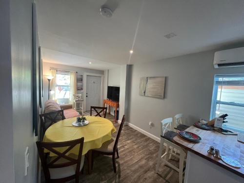 a kitchen and dining room with a yellow table and chairs at St Petersburg Vacation Rentals in St Petersburg