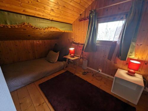 a small room with a bed and a window at Domaine d'Avallon - petit Tibet au coeur des Alpes in Arvillard