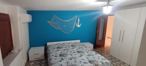 una camera da letto con una parete blu e un letto di Azzurro come il Mare a Termoli