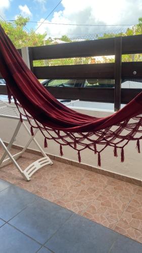 a hammock is tied to a bench on a patio at La maison de la plage in Sainte-Luce