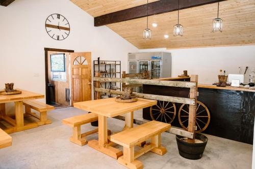 a room with wooden tables and a clock on the wall at The Lodge at Silver Ridge Ranch in Cabin Creek