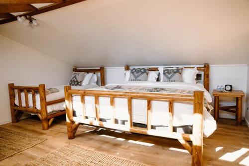 a bedroom with a large wooden bed and a chair at The Lodge at Silver Ridge Ranch in Cabin Creek