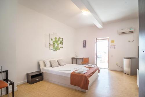 um quarto branco com uma cama num quarto em Hostel Cazino Nord Rooms em Mamaia