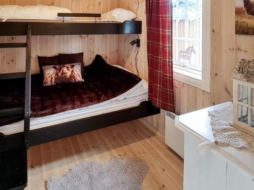 a bedroom with two bunk beds in a room at Holiday home Engerdal 
