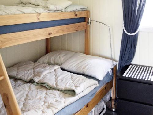 a couple of bunk beds in a room at Holiday home Klokkarstua in Svelvik