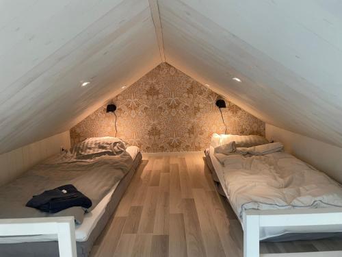 a bedroom with two beds in a attic at Lilla kyrkhuset på Råå in Helsingborg