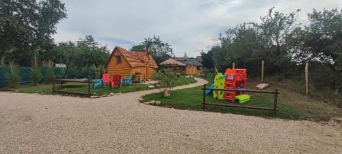 a childrens playground with a wooden house at Cabane Kota finlandais in Laives