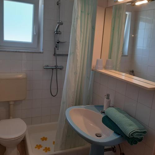 a bathroom with a sink and a toilet and a shower at Apartment Meri in Klimno
