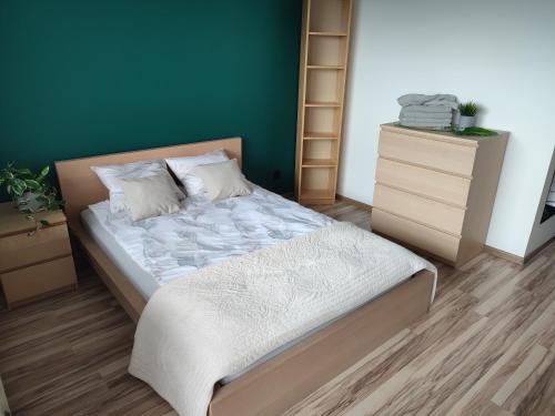 sypialnia z łóżkiem i zieloną ścianą w obiekcie Chill Studio w Łodzi