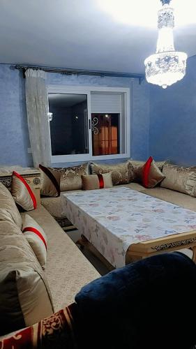 uma sala de estar com um sofá e uma mesa em شقة مجهزة بالكامل em Saïdia