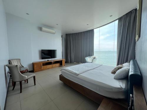a hotel room with a bed and a large window at Nancy Vung Tau Villa in Vung Tau