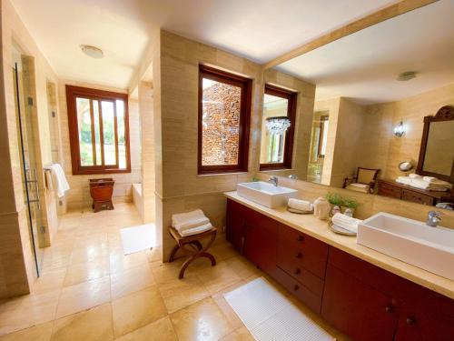 a bathroom with two sinks and two mirrors at 5-Bedroom Villa with Private Pool, Maid and Golf Course Views at Casa de Campo Resort in La Romana