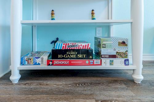 a white shelf with boxes of food on it at Hot Tub and Jacuzzi Suite! 100 steps from spacious beach and Jetty park! Generations Retreat Sleeps 26 in Surfside Beach