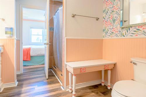 a small bathroom with a toilet and a sink at Hot Tub and Jacuzzi Suite! 100 steps from spacious beach and Jetty park! Generations Retreat Sleeps 26 in Surfside Beach