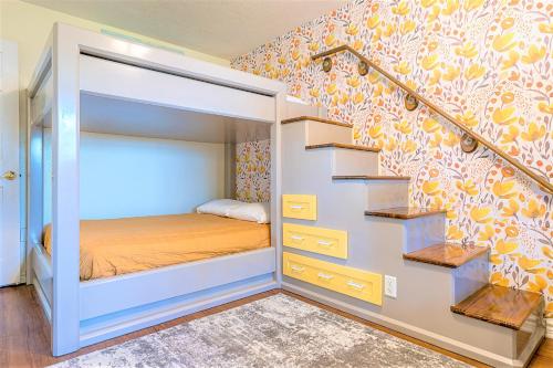 a small bedroom with a bunk bed and stairs at Hot Tub and Jacuzzi Suite! 100 steps from spacious beach and Jetty park! Generations Retreat Sleeps 26 in Surfside Beach