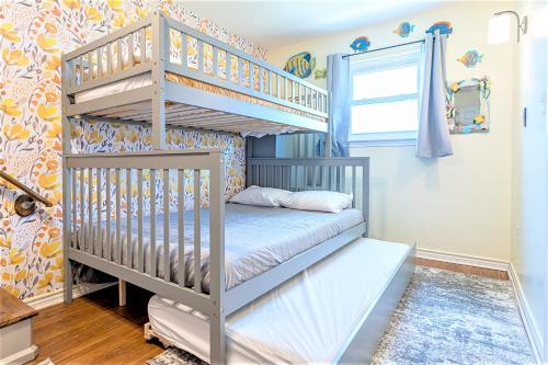 a childs bedroom with a bunk bed at Hot Tub and Jacuzzi Suite! 100 steps from spacious beach and Jetty park! Generations Retreat Sleeps 26 in Surfside Beach