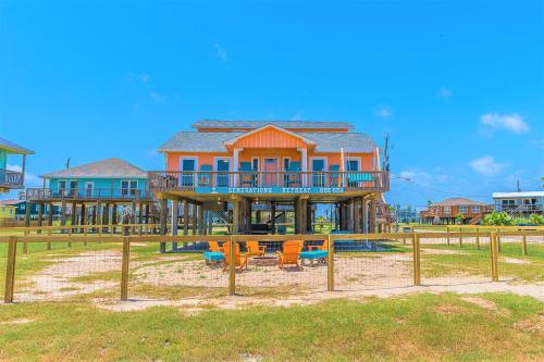 a large house with a playground in front of it at Hot Tub and Jacuzzi Suite! 100 steps from spacious beach and Jetty park! Generations Retreat Sleeps 26 in Surfside Beach