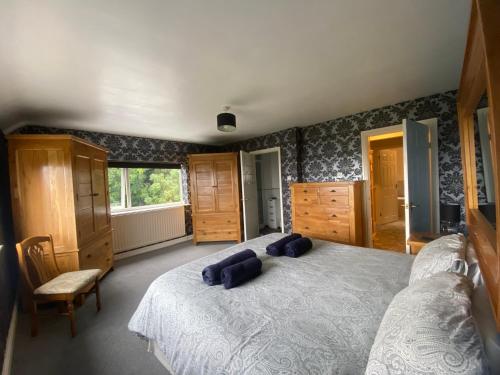 a bedroom with a large bed with two pillows on it at Carreg Y Garth Isaf - Hot Tub Nr Zip World in Bangor