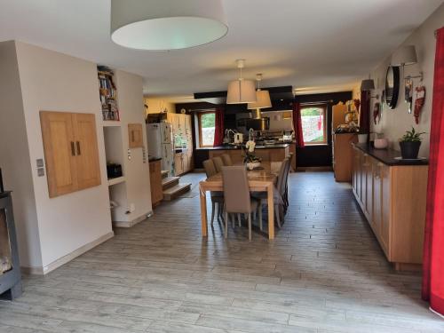 une cuisine et une salle à manger avec une table et des chaises dans l'établissement Belle Villa en Ardèche Verte, à Vocance