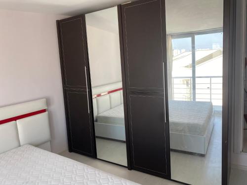 a black cabinet in a bedroom with a bed at Denize 800 m villamız in Aksu