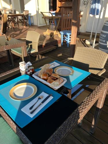 a table with a plate of food on it at Logis Hôtel-Restaurant Les Voyageurs in La Coquille