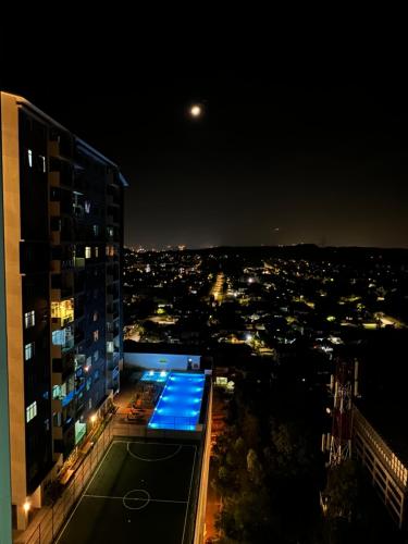 a view of a city at night from a building at Ilsham Guest House @ Seroja Hills BBST Sepang in Sepang